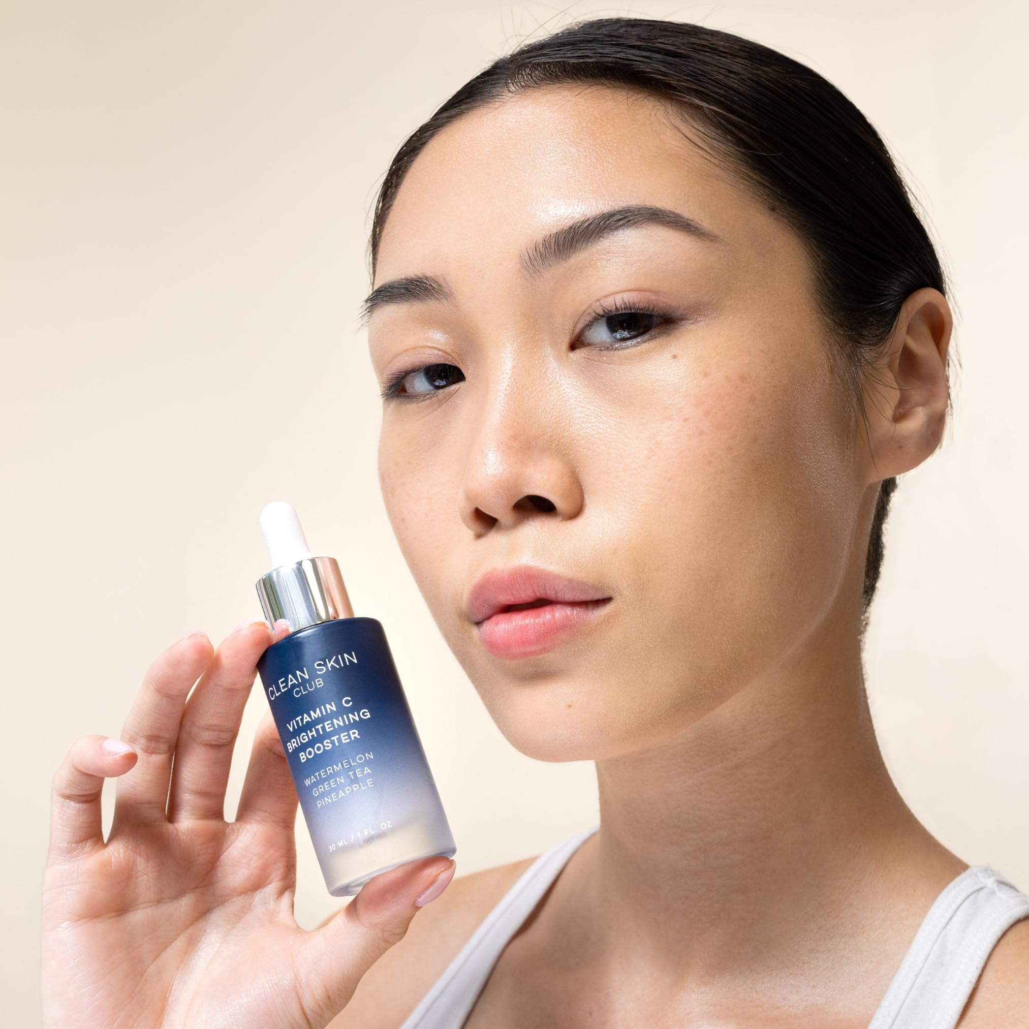 Clean Skin Club brightening booster packaging highlights antioxidant protection for visible glow.