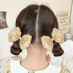 CN gold glitter hair bow clip worn in wedding-ready hairstyle adds elegance