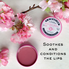 C.O. Bigelow Sakura Rose Salve tin on a desk for quick hydration during work.