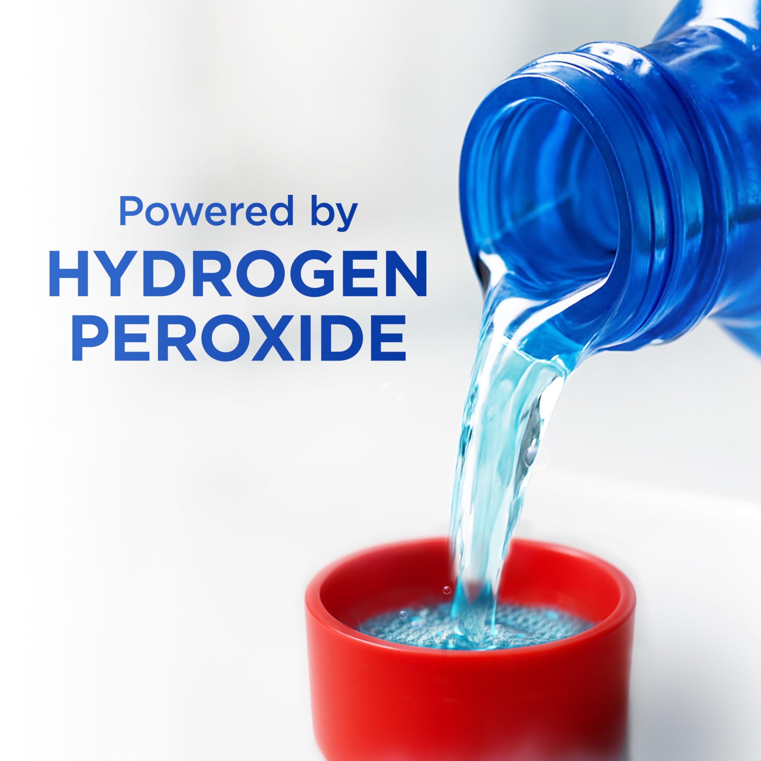 Colgate Peroxyl held in hand showing 16.9 fl oz size for scale and portioning