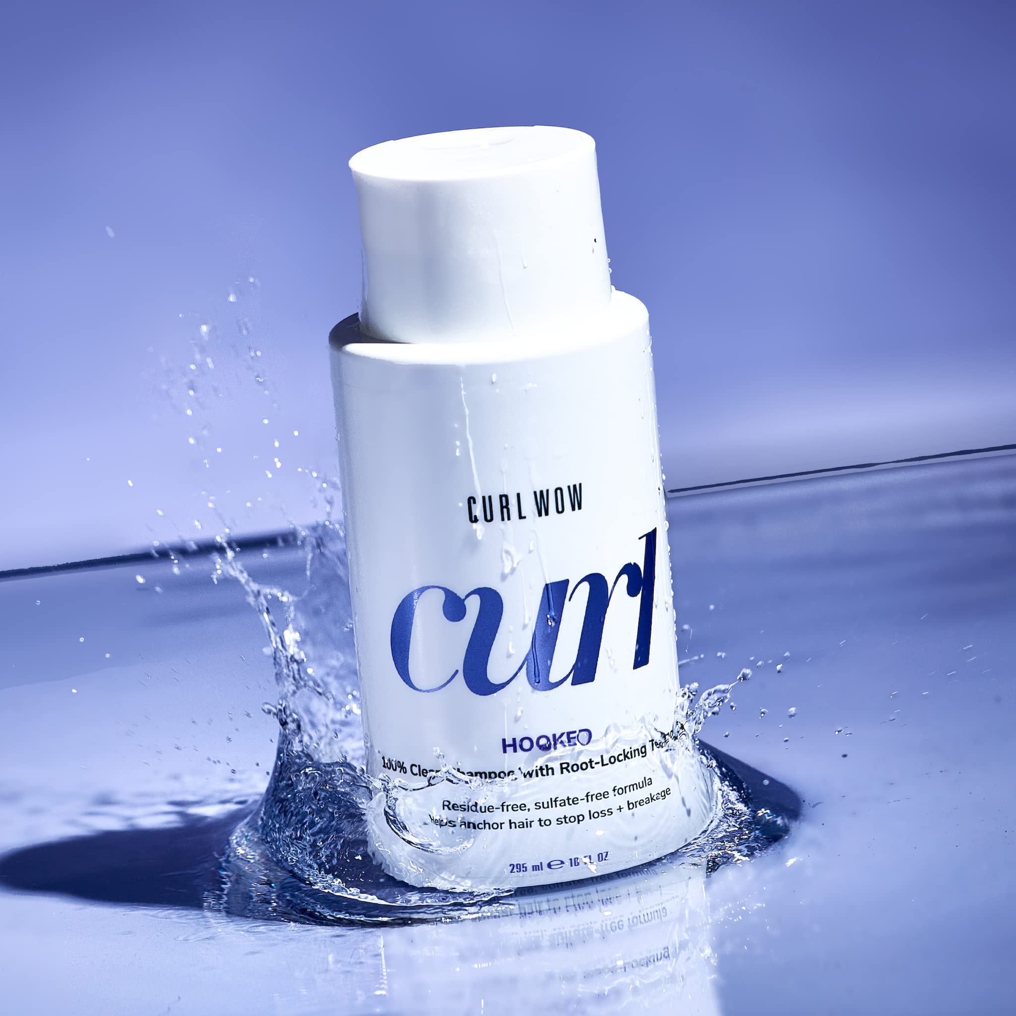 COLOR WOW Curl Wow Hooked bottle pour demonstrates easy, even lather for curls.