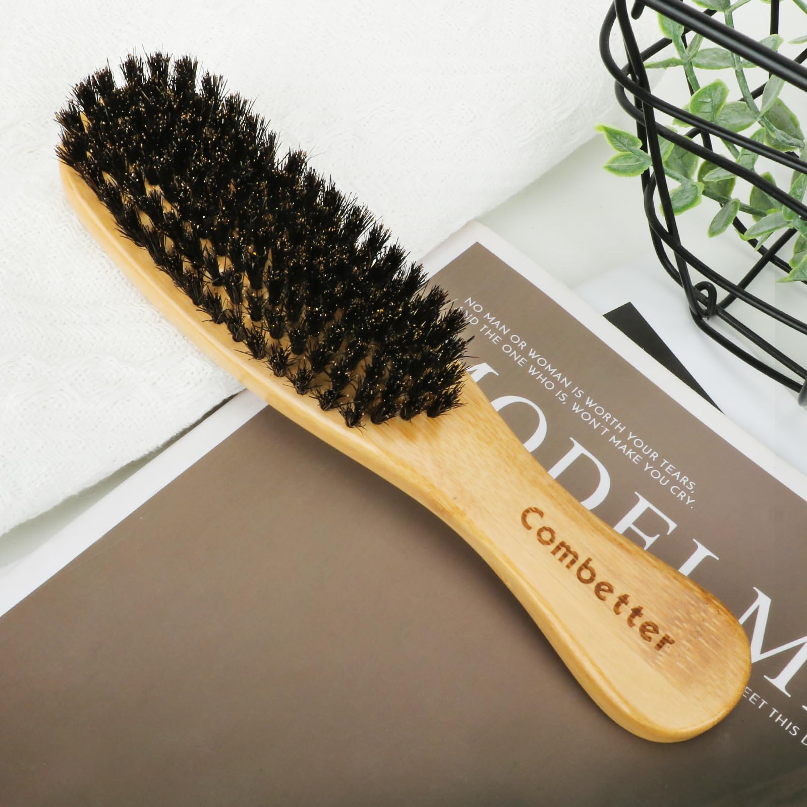 Combetter boar-bristle brush suitable for all hair types including curly and straight.