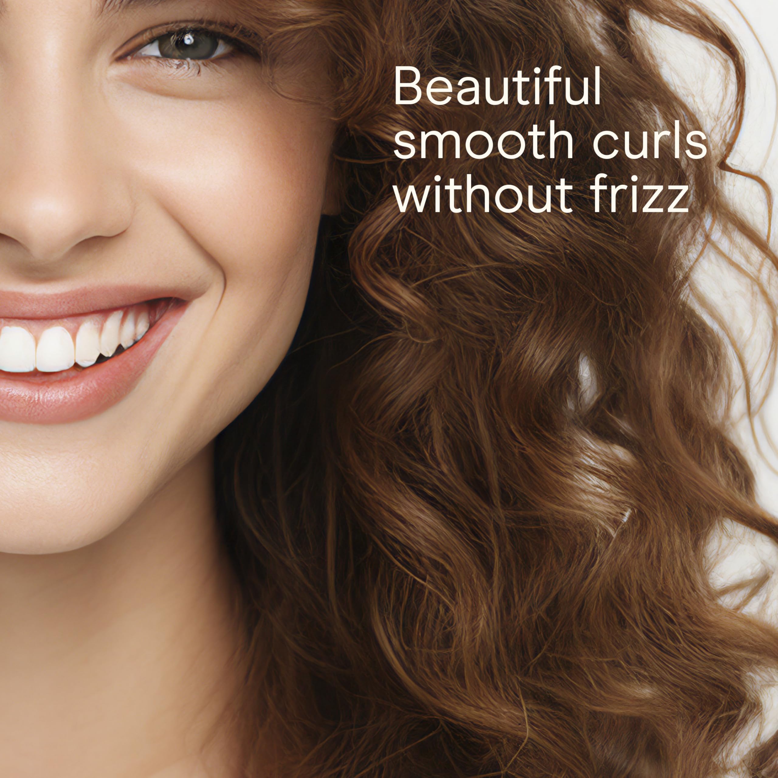 Conair Infiniti Pro clamp curling iron guiding hair for classic curls.
