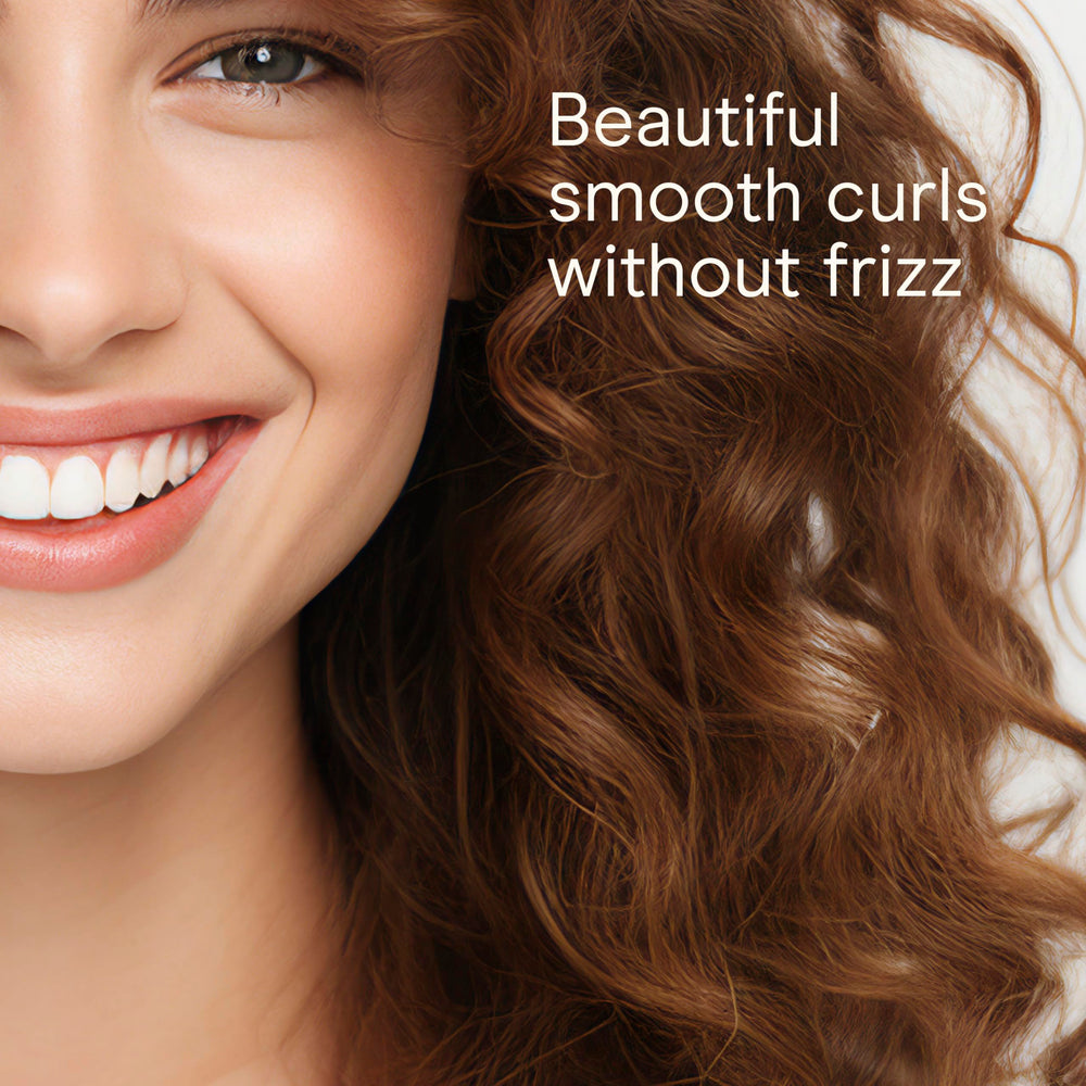 Conair Infiniti Pro clamp curling iron guiding hair for classic curls.