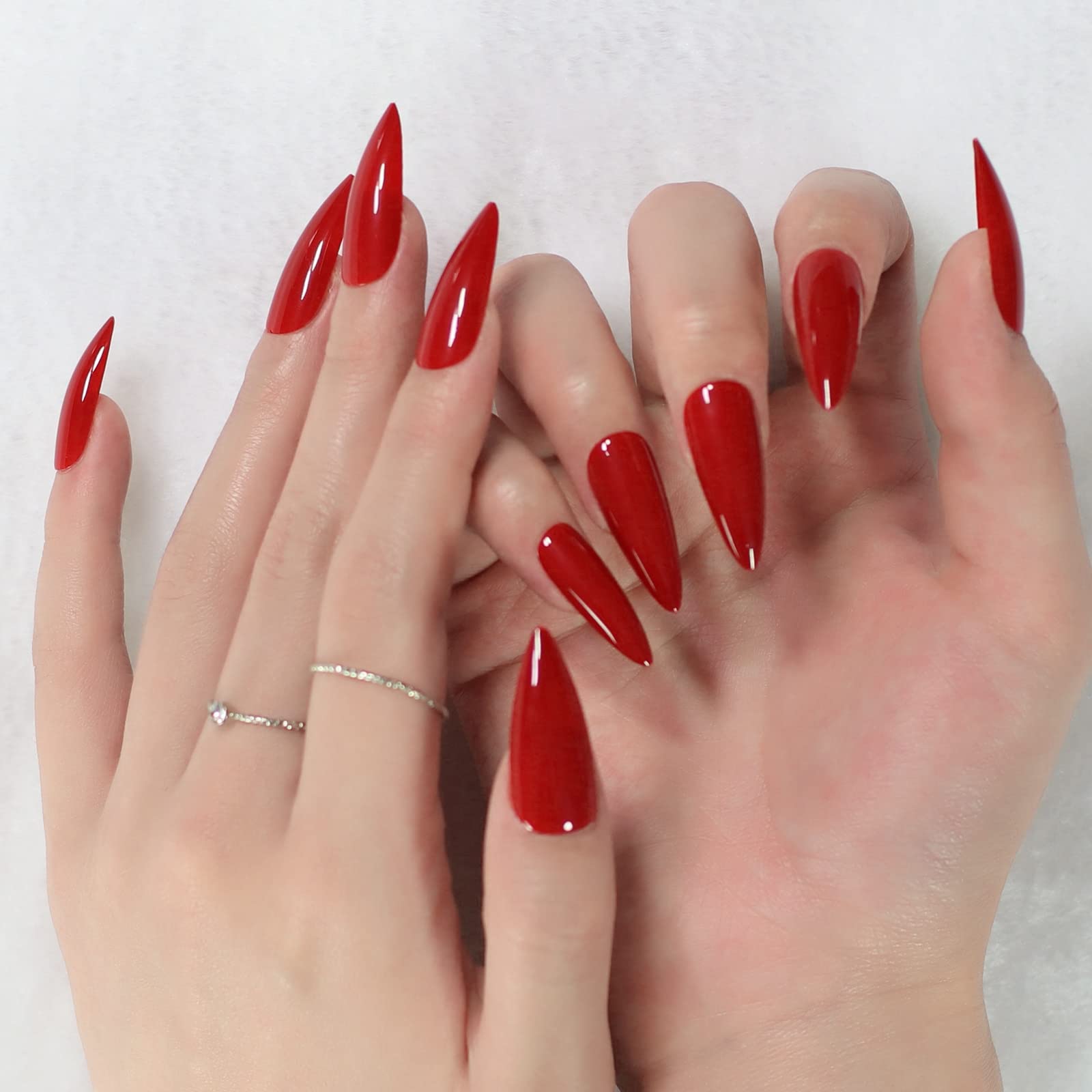 Coolnail glossy red stiletto nails laid out with varied sizes for precise DIY fit
