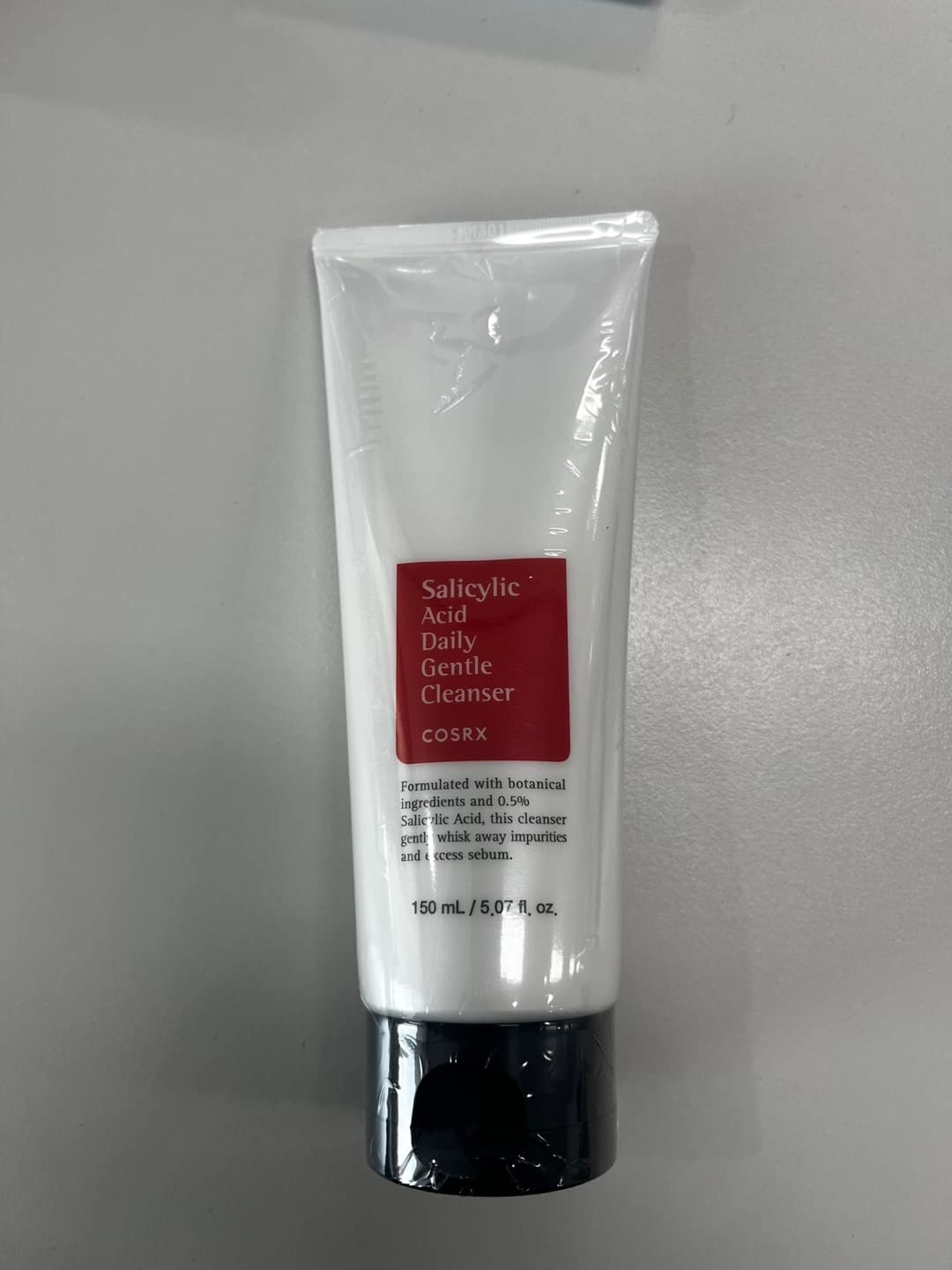 COSRX daily cleanser foaming texture with bubbles indicating gentle cleansing.