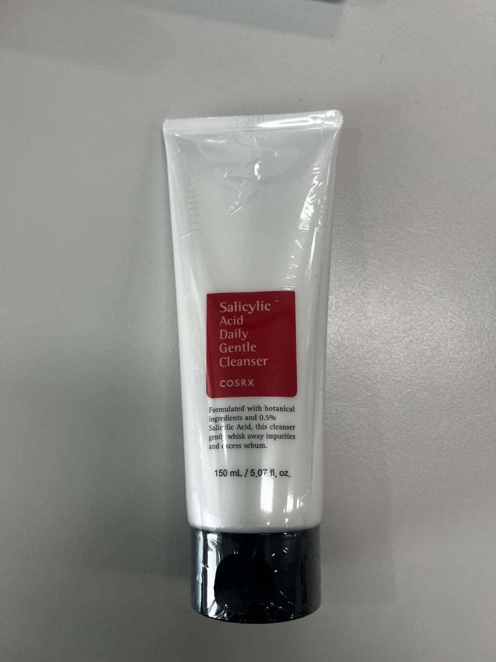 COSRX daily cleanser foaming texture with bubbles indicating gentle cleansing.