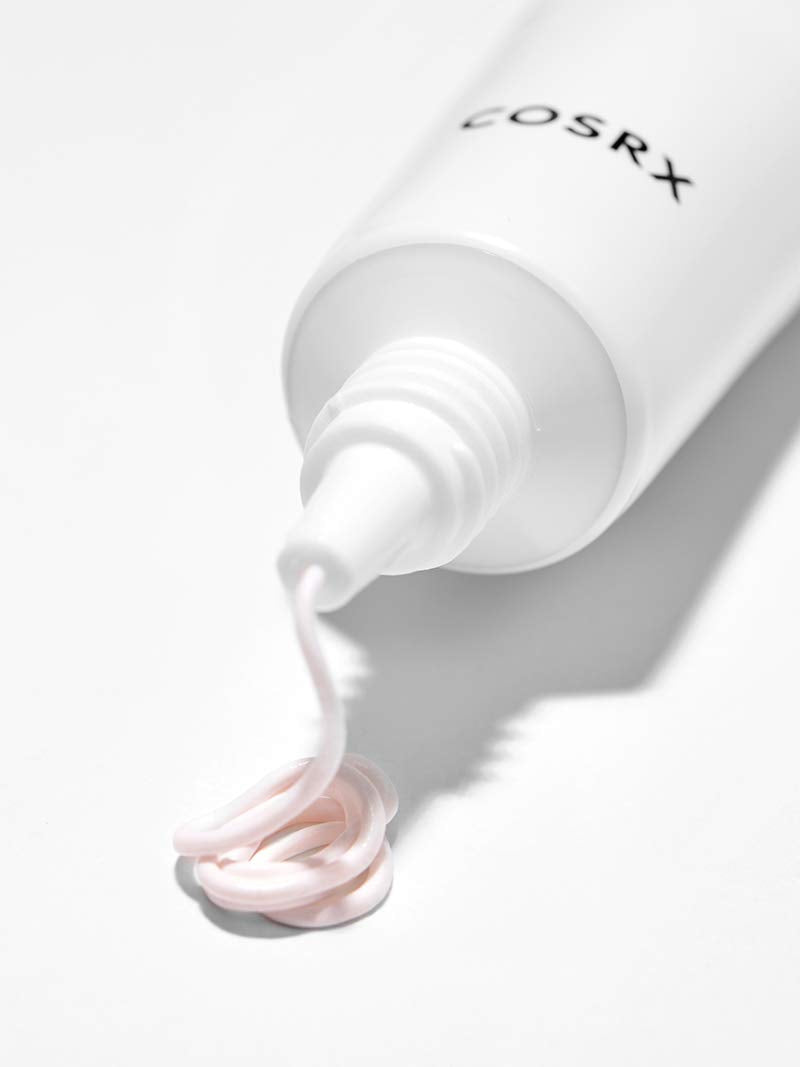 COSRX Ultimate Spot Cream texture on hand indicating quick absorption and use.