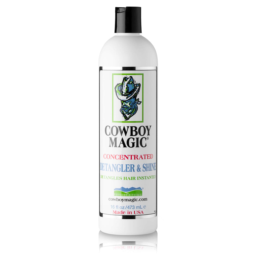 Hands brushing coat with Cowboy Magic for a silky finish.