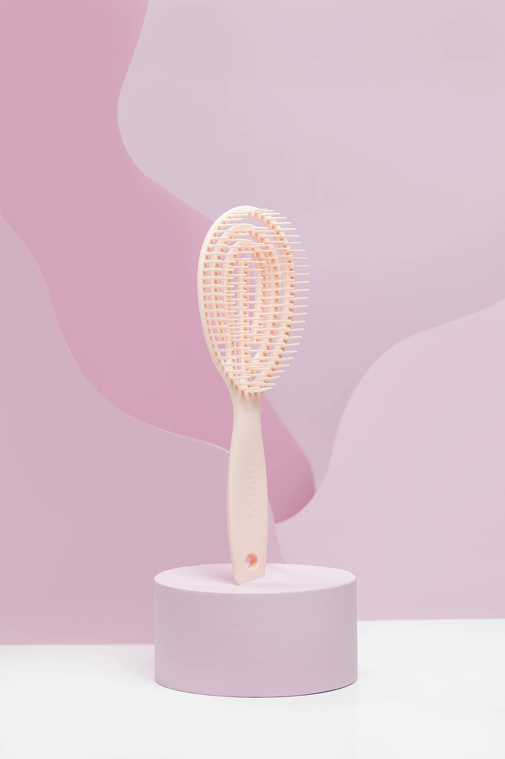 Crave Naturals FLEX DMC detangling brush in dry-use context for knot-free detangling.