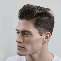 Hands applying Cremo paste to hair for texture and definition