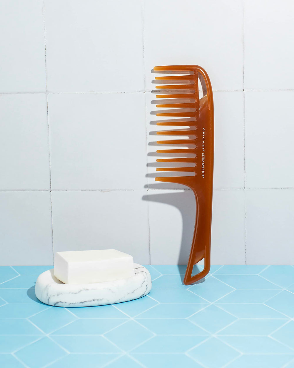 Cricket detangler on dry hair, reduces frizz with wide-teeth design.