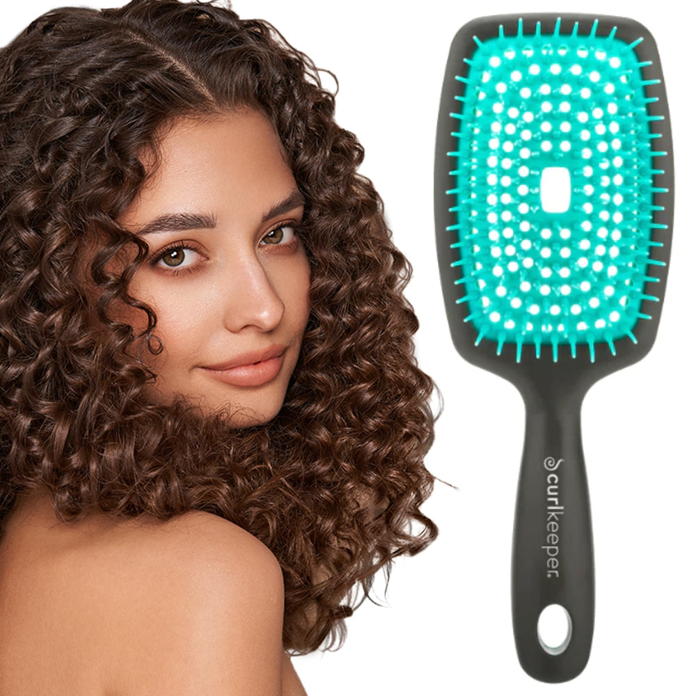 Curl Keeper Flexy Brush turquoise closeup shows flexible bristles for detangling.
