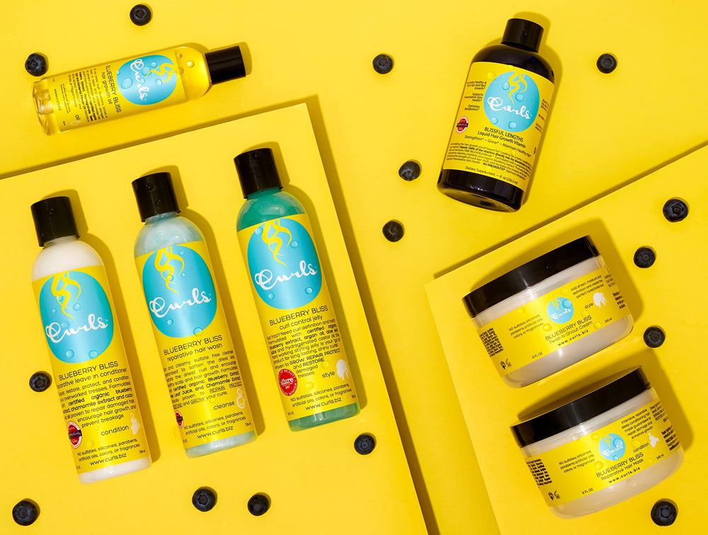 Curls Blueberry Bliss vibrant curls with hydrated, defined texture.