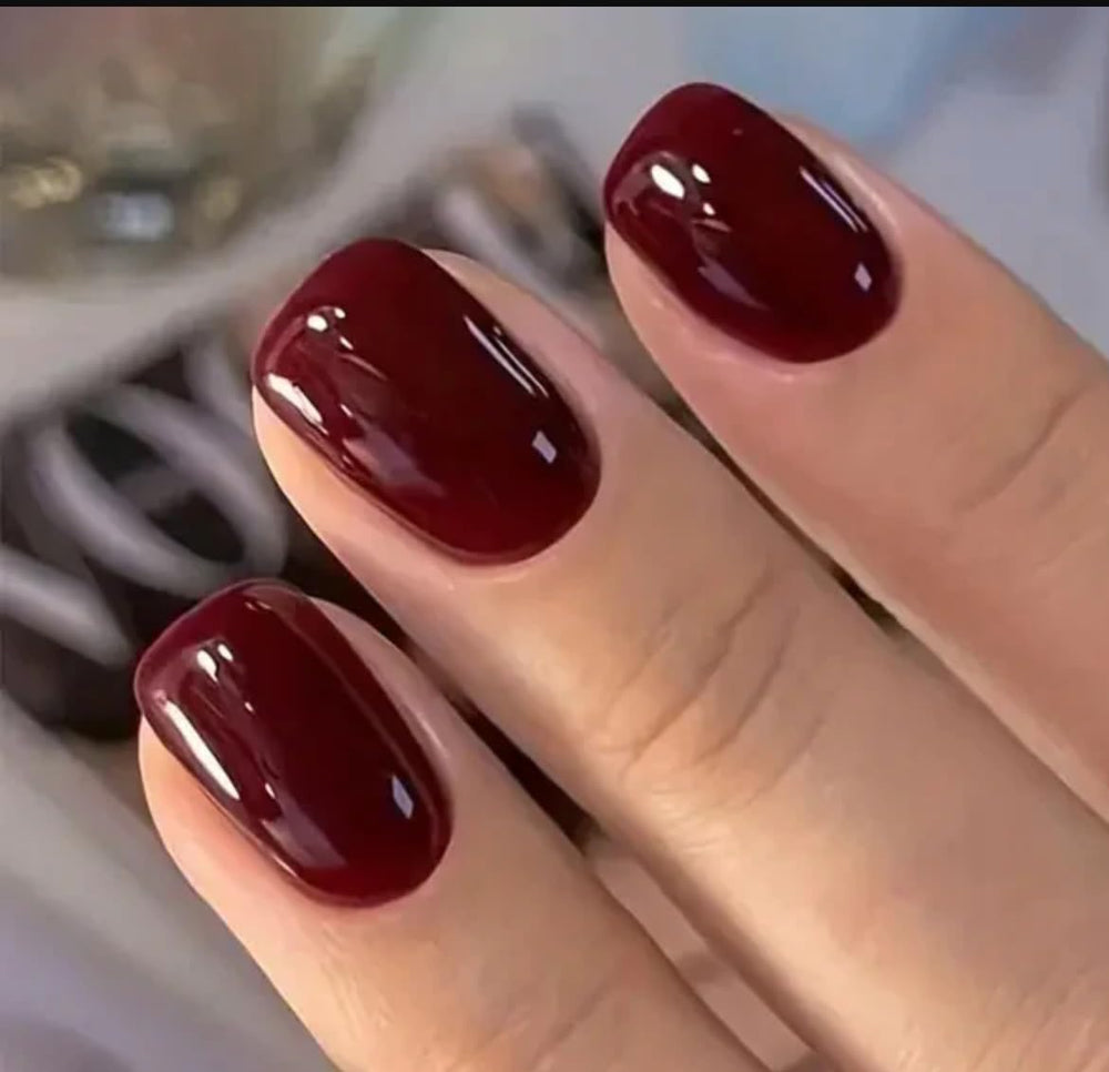Curvlife press-on nails short wine-red on hand demonstrating natural fit and comfortable wear.