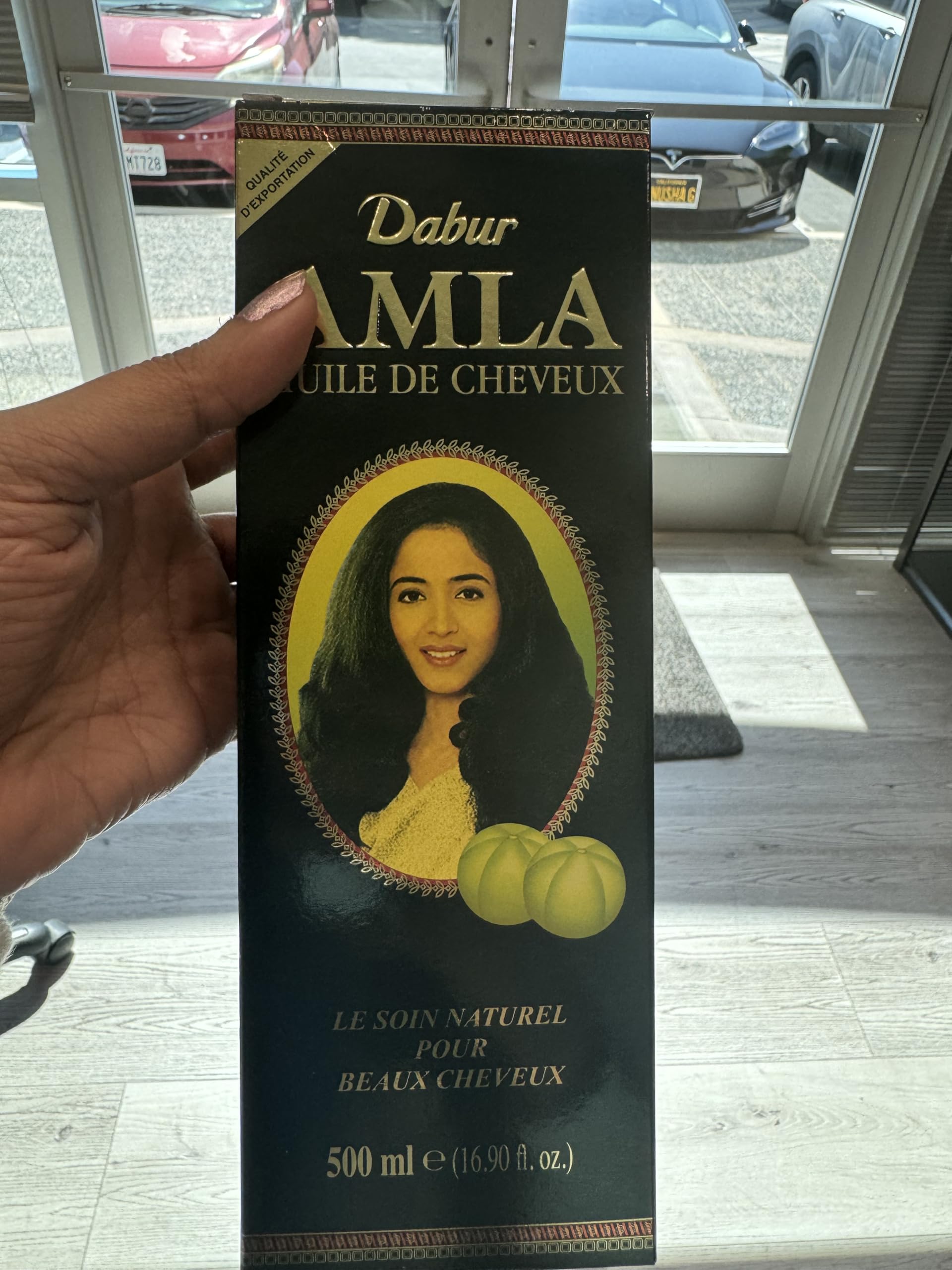 Dabur Amla Hair Oil bottle pour shows easy scalp nourishment application.