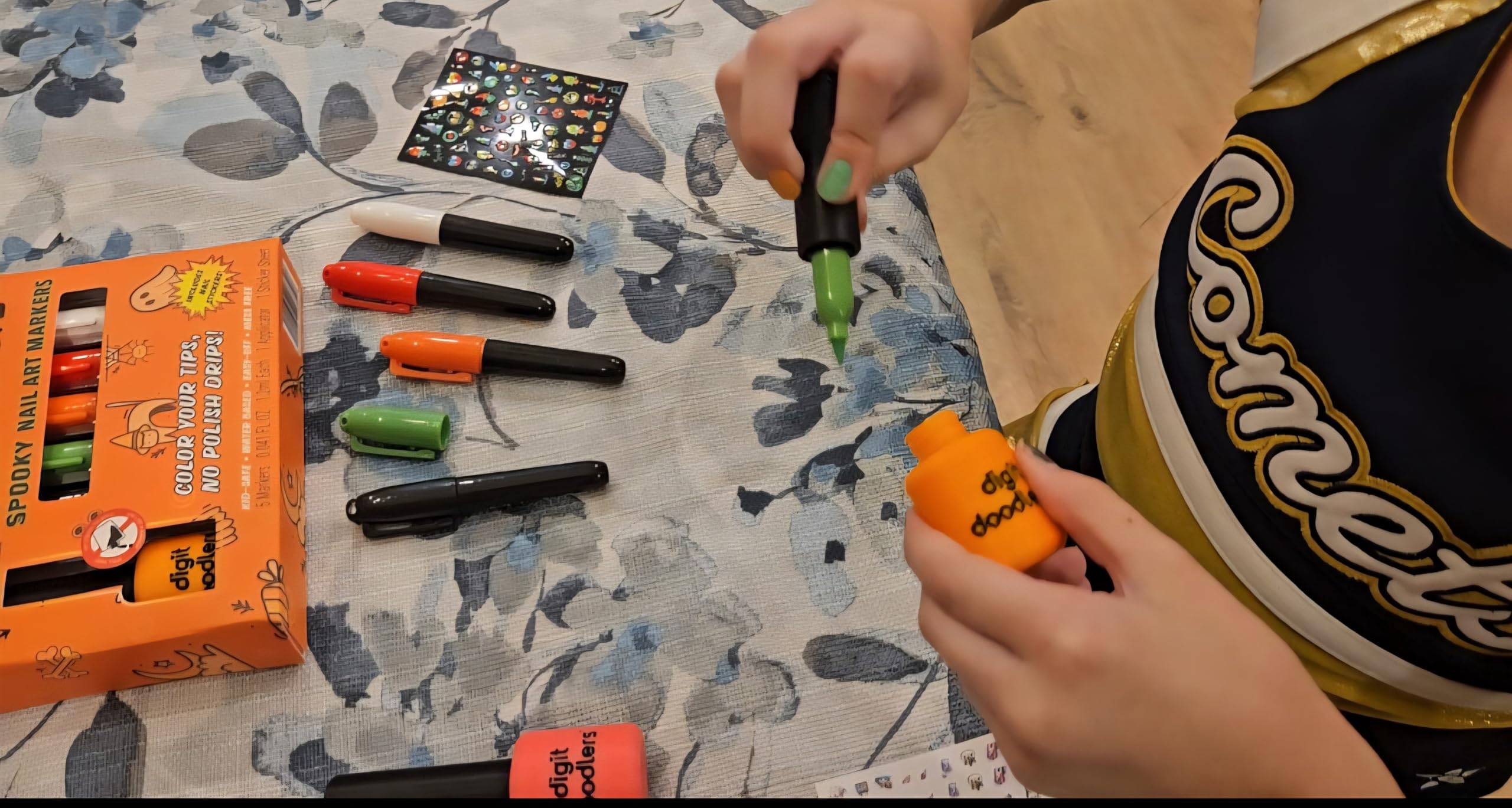 DaddyCo kid hands crafting with markers during imaginative play.