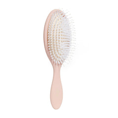 DAE Vegan Detangle Style Brush in hand shows gentle detangling for all hair types.