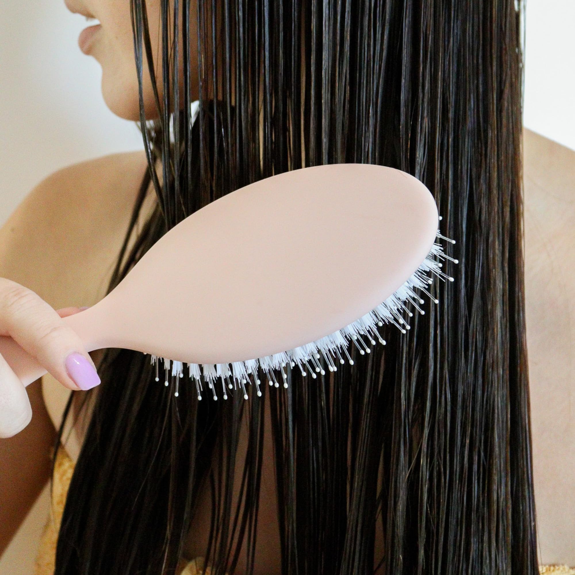 DAE Detangle Brush shown on wet hair for quick detangling and styling.