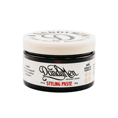 DandyMen styling paste bottle view shows versatile medium hold for all-day style.