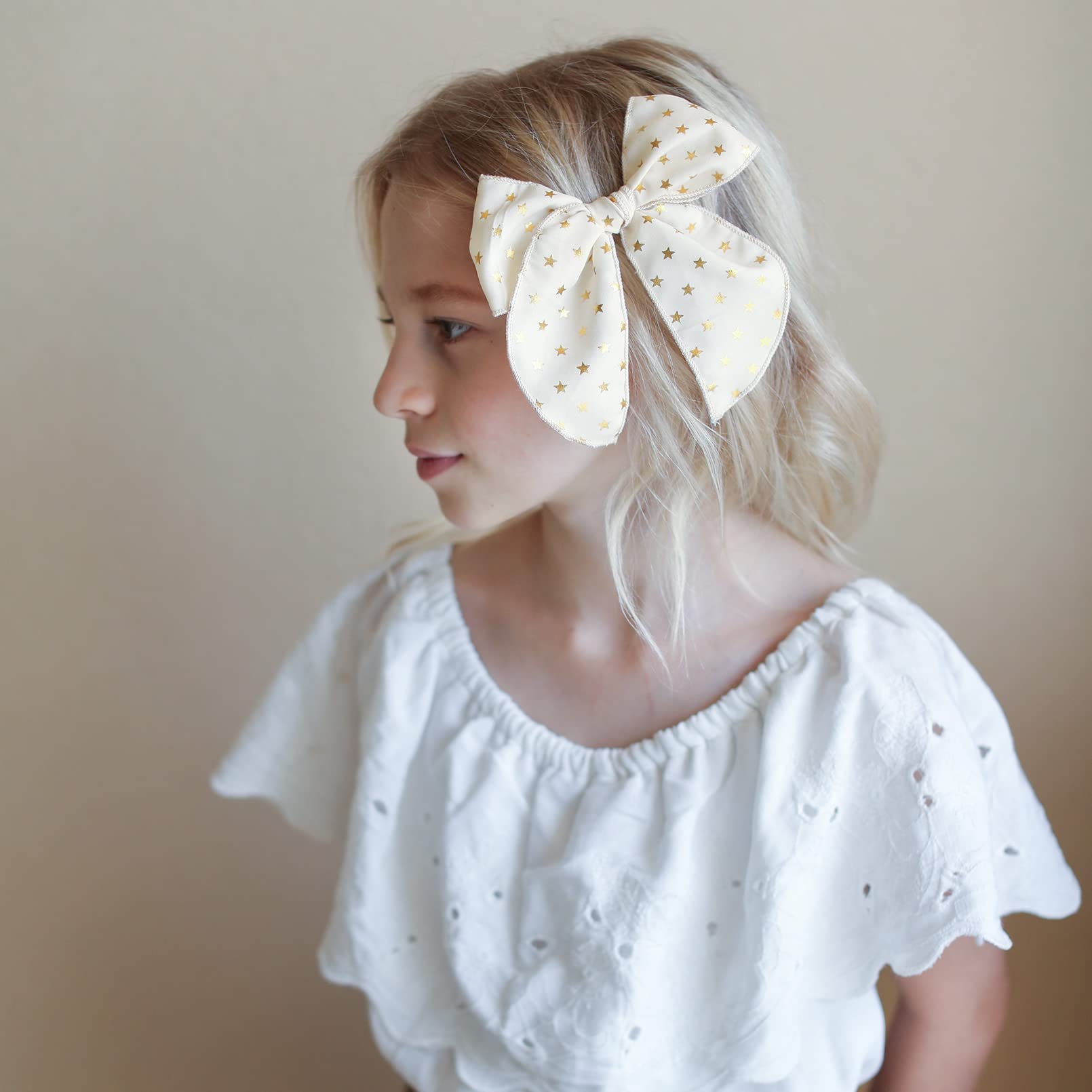 DEEKA beige star bow features subtle shine for occasions.
