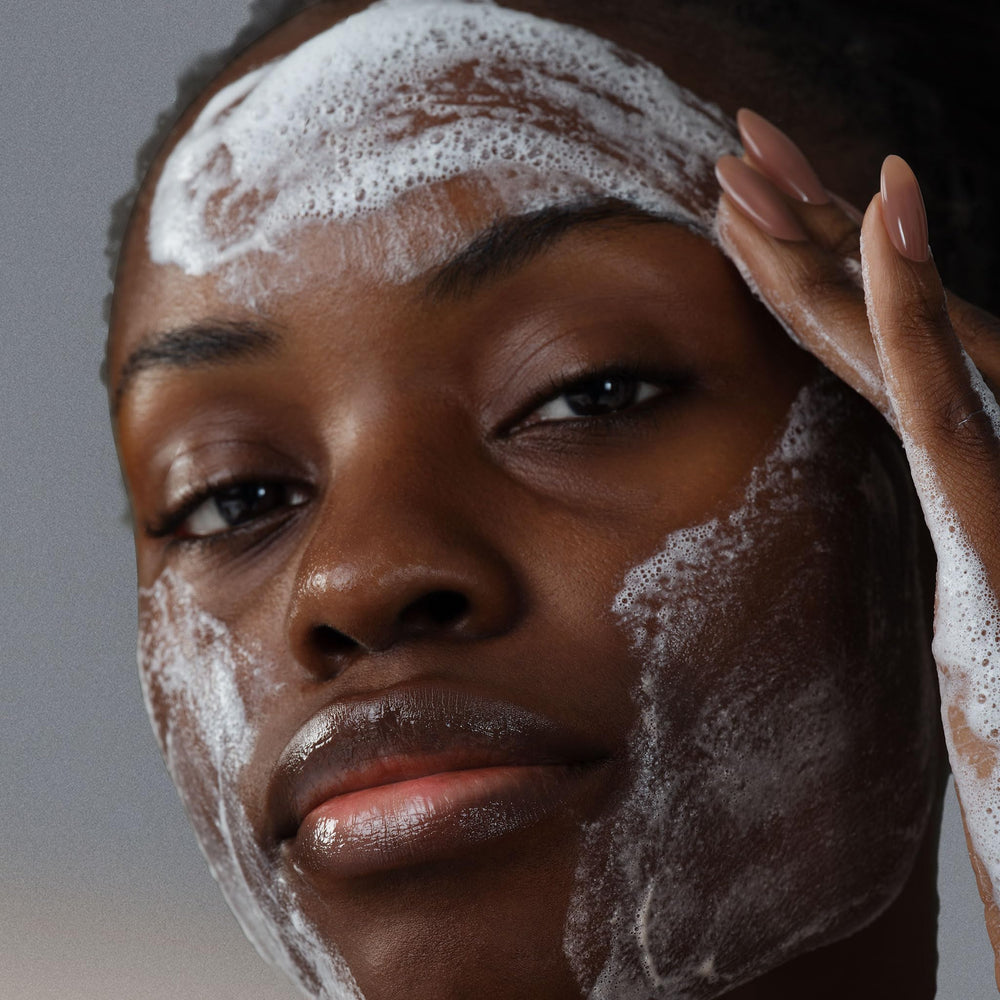 Dermalogica AGE Bright Clearing Serum being dabbed on cheek for brightening