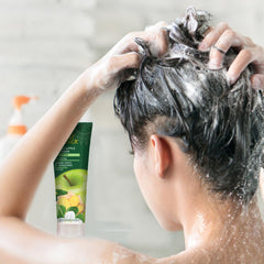 Desert Essence thickening shampoo on hair during application showing body and lift.
