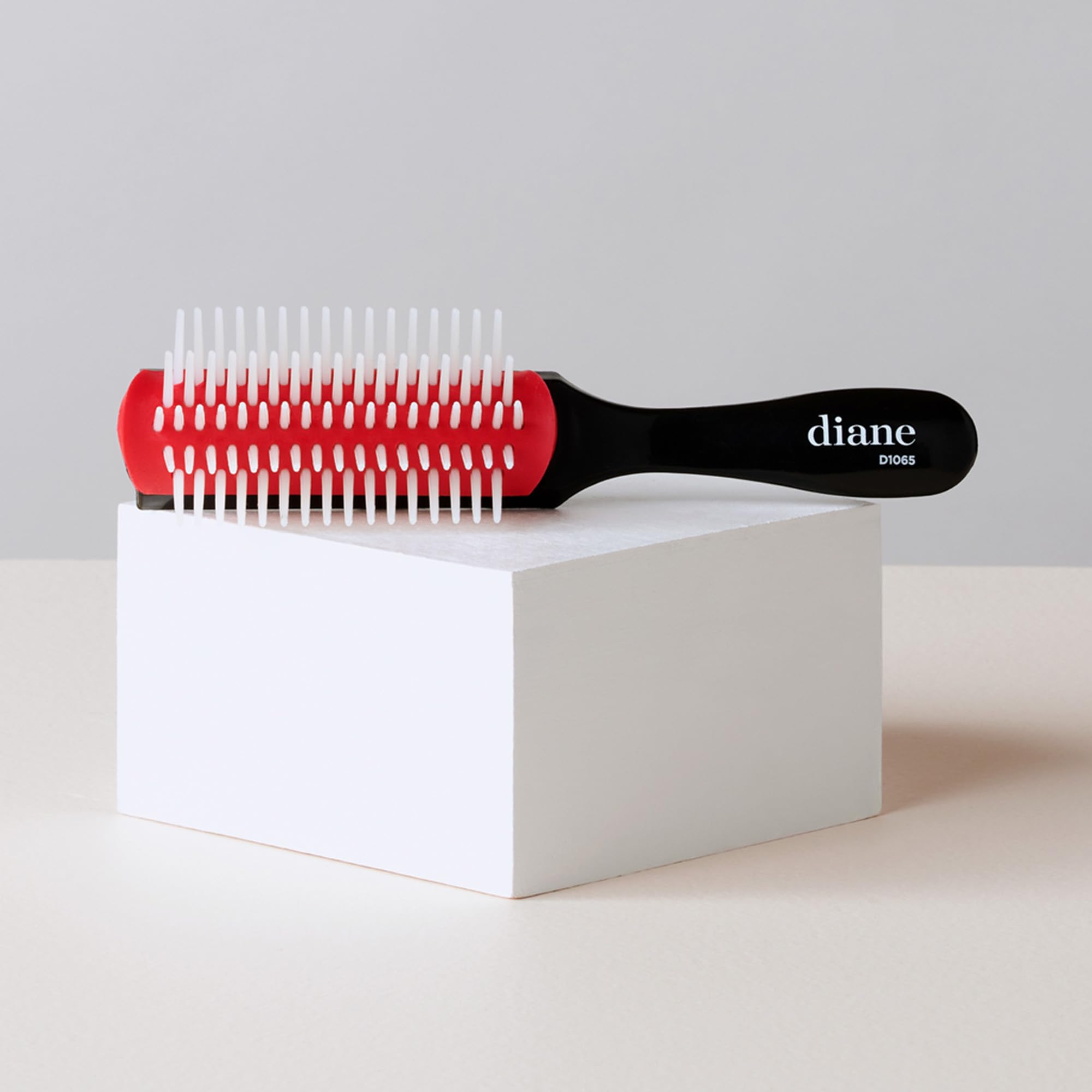 Diane Pro Mini Nylon Pin Styling Brush showing anti-static cushion for frizz control.