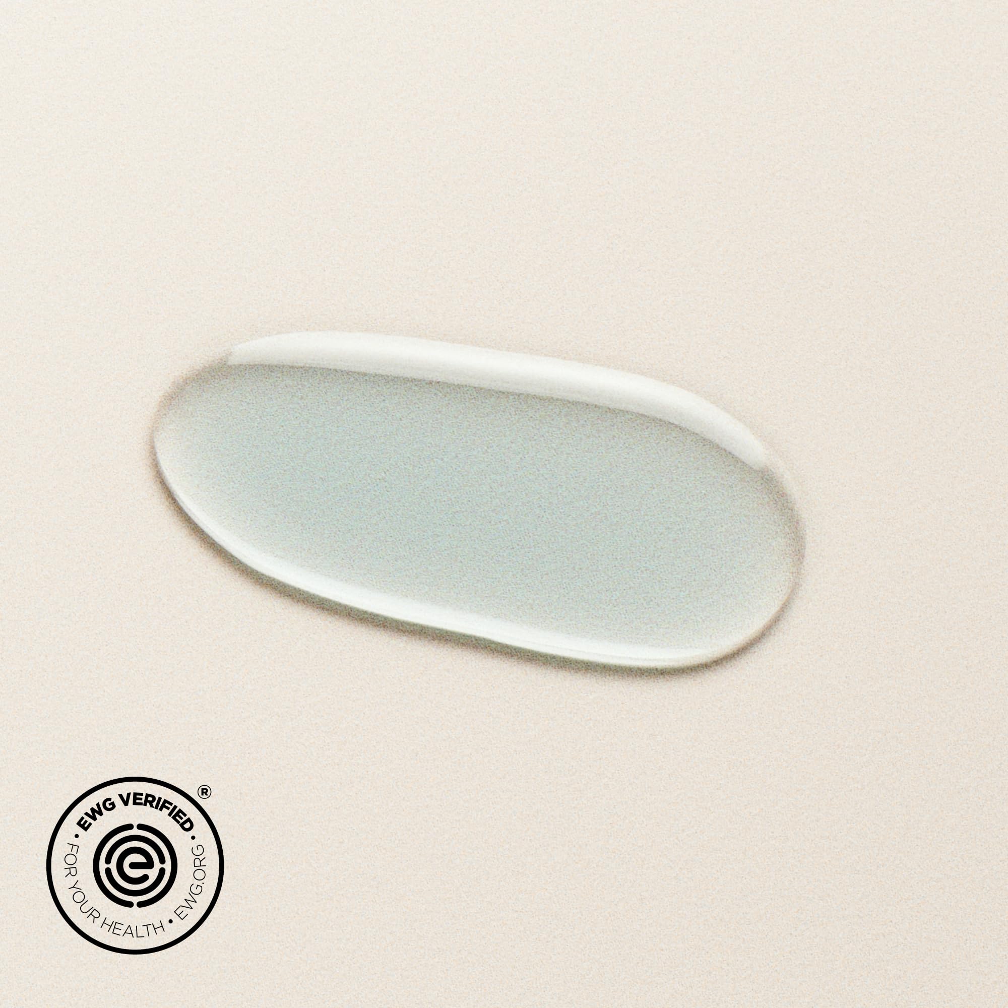 DIME Beauty Blue Facial Oil being gently patted onto the face.