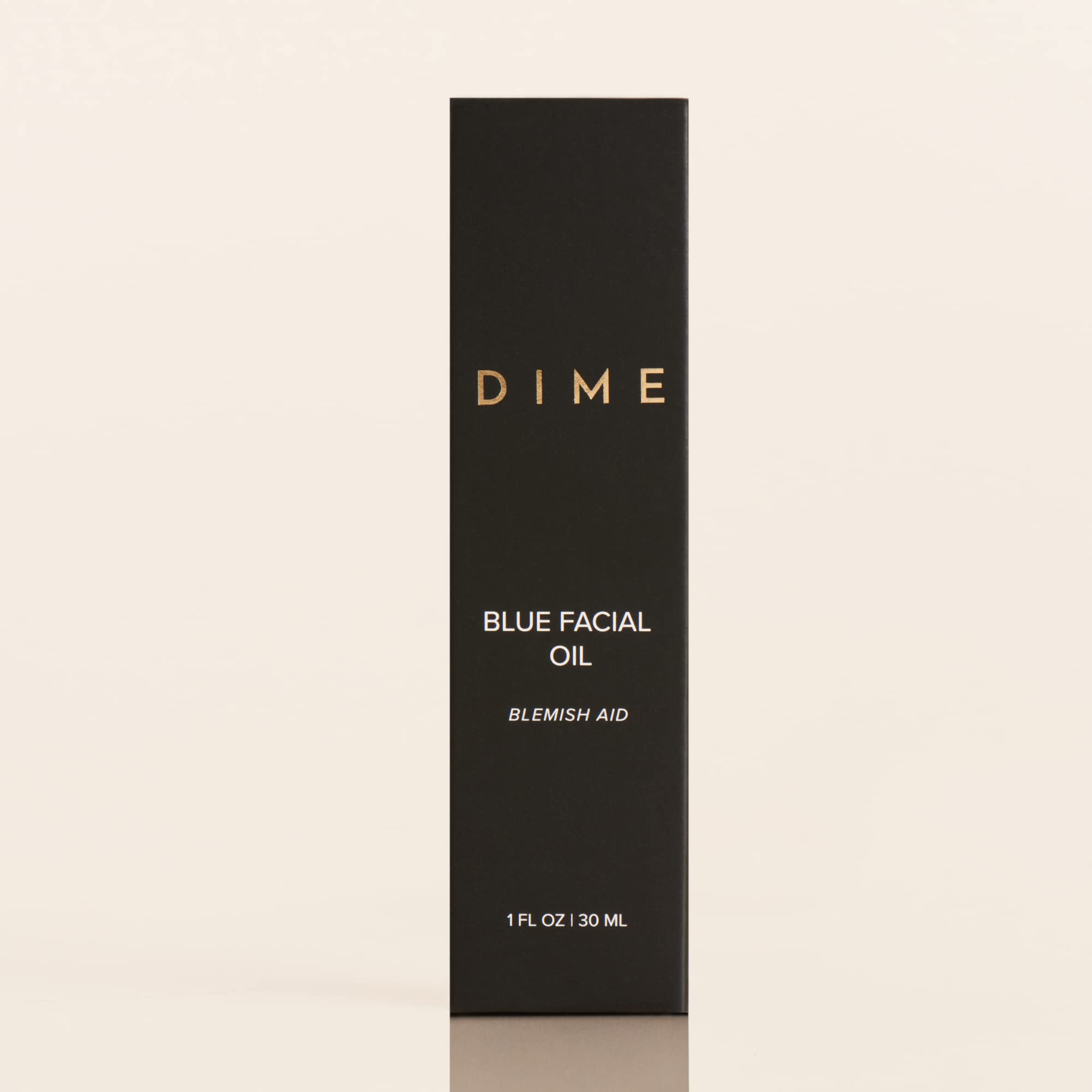 DIME Beauty Blue Facial Oil on a clean surface highlighting premium packaging and formula.