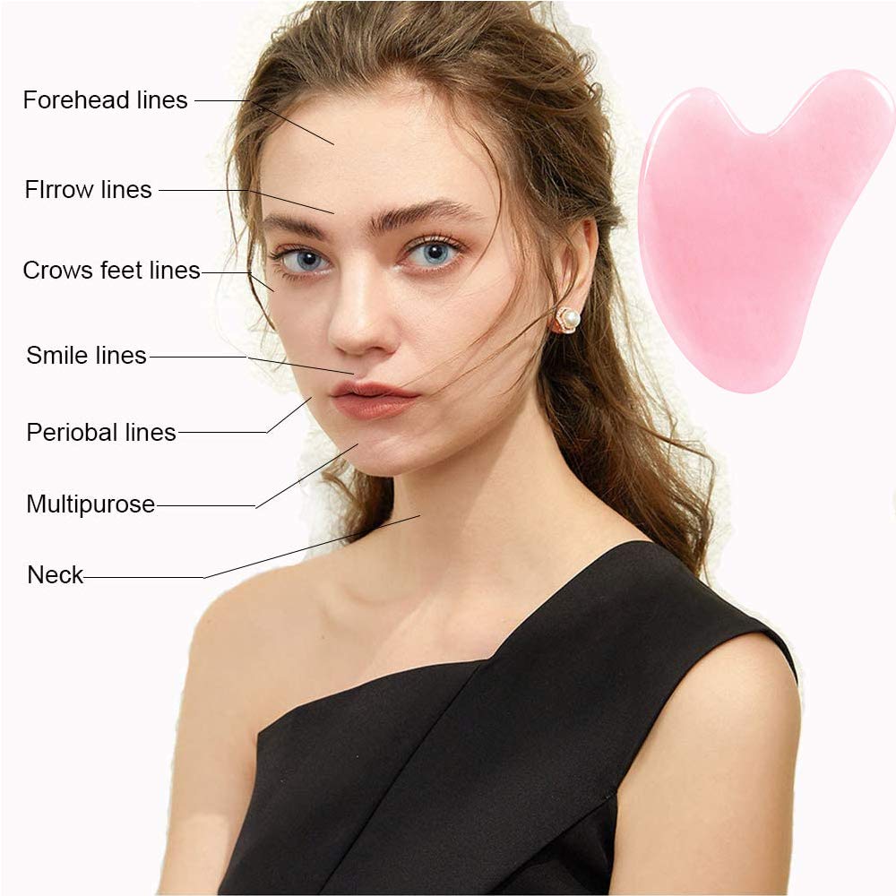 Ditind Rose Quartz Gua Sha with facial oil on skin to boost absorption.