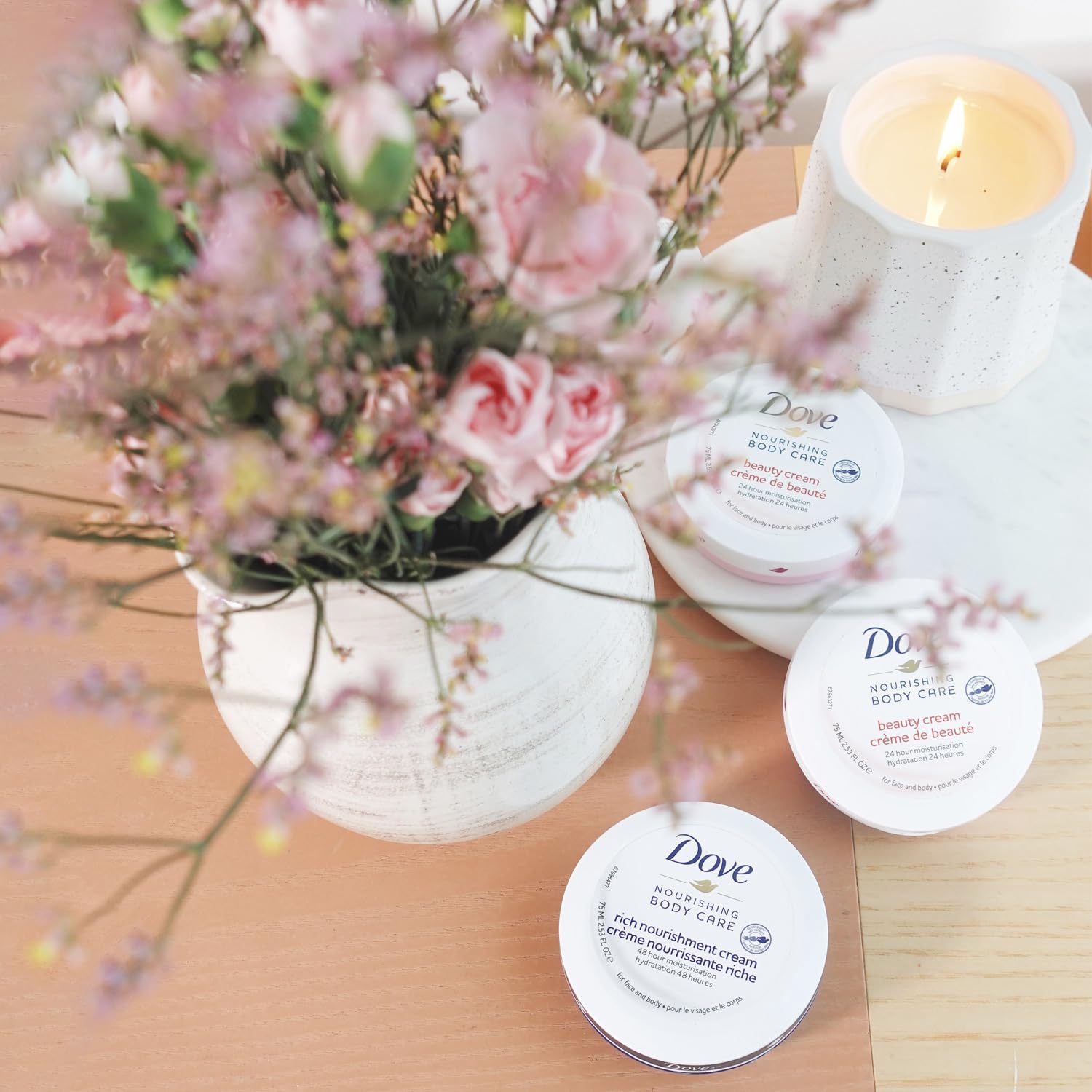Dove Body Love Rich Nourishment Cream application on hand for quick absorption.