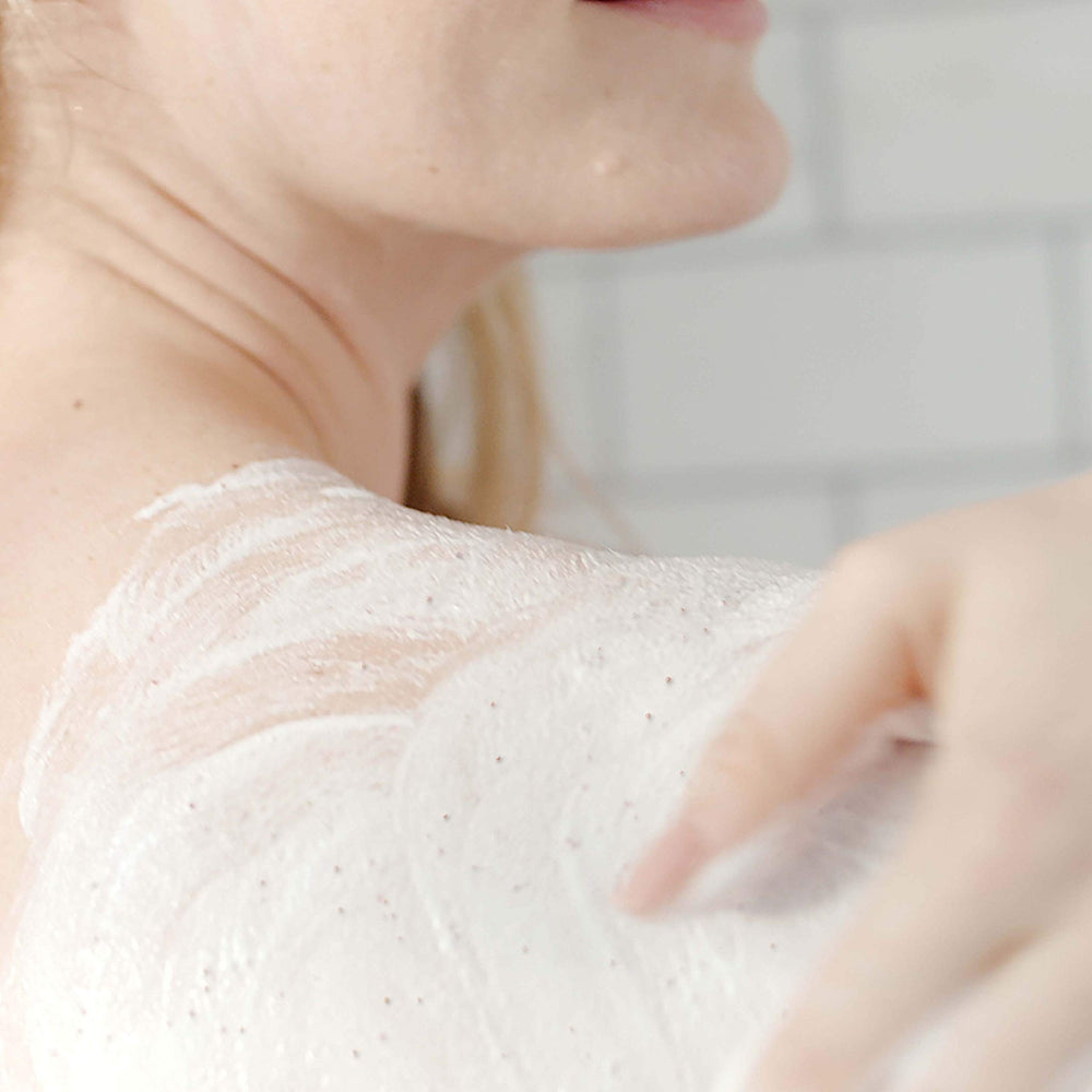 Dove Exfoliating Body Polish aiding in beach-ready skin look
