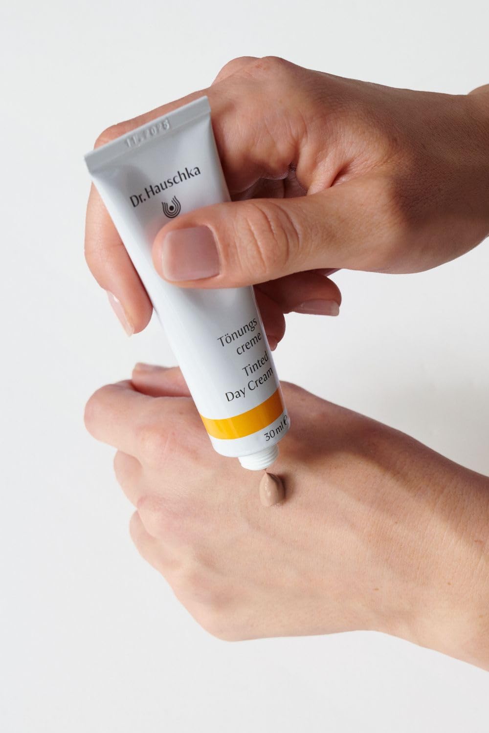 Dr Hauschka Tinted Day Cream packaging box emphasizes natural ingredients and premium care.