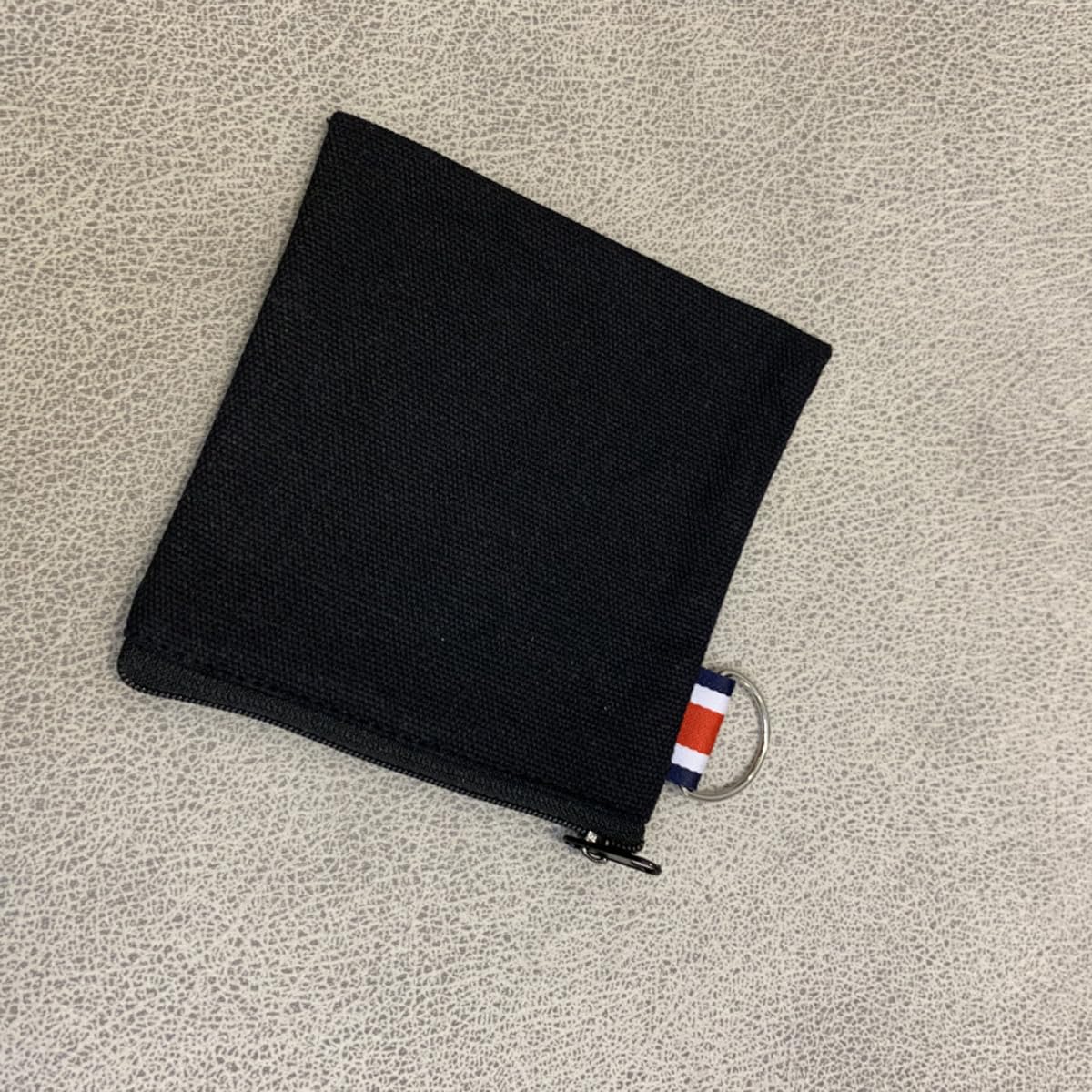 DraCra white canvas pouch with ring keeps lipsticks and coins neatly organized.