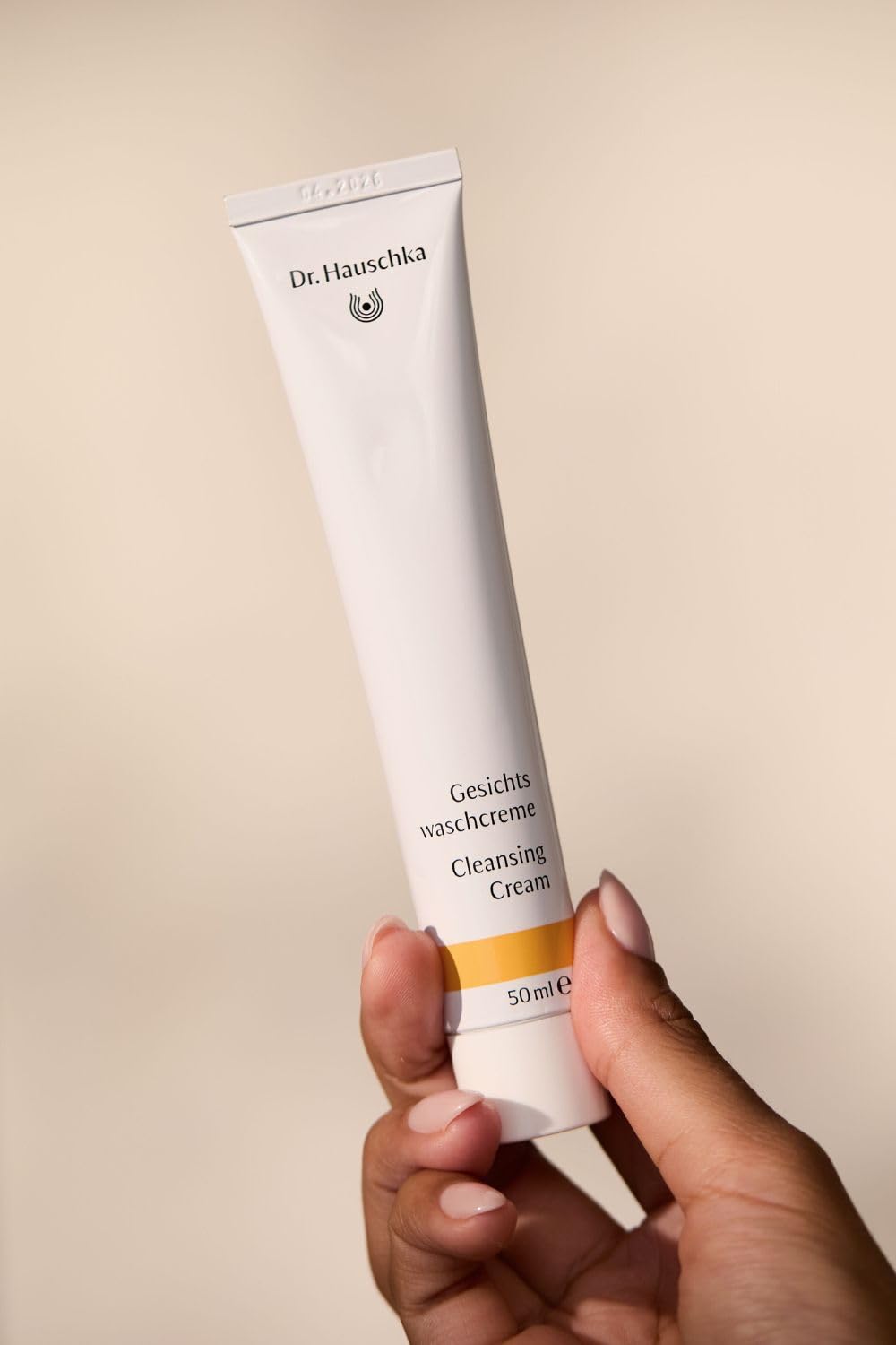 Dr. Hauschka Cleansing Cream label close-up emphasizes botanicals for daily care.