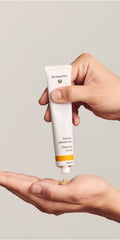 Dr. Hauschka Cleansing Cream packaging on counter supports a consistent daily skincare ritual.