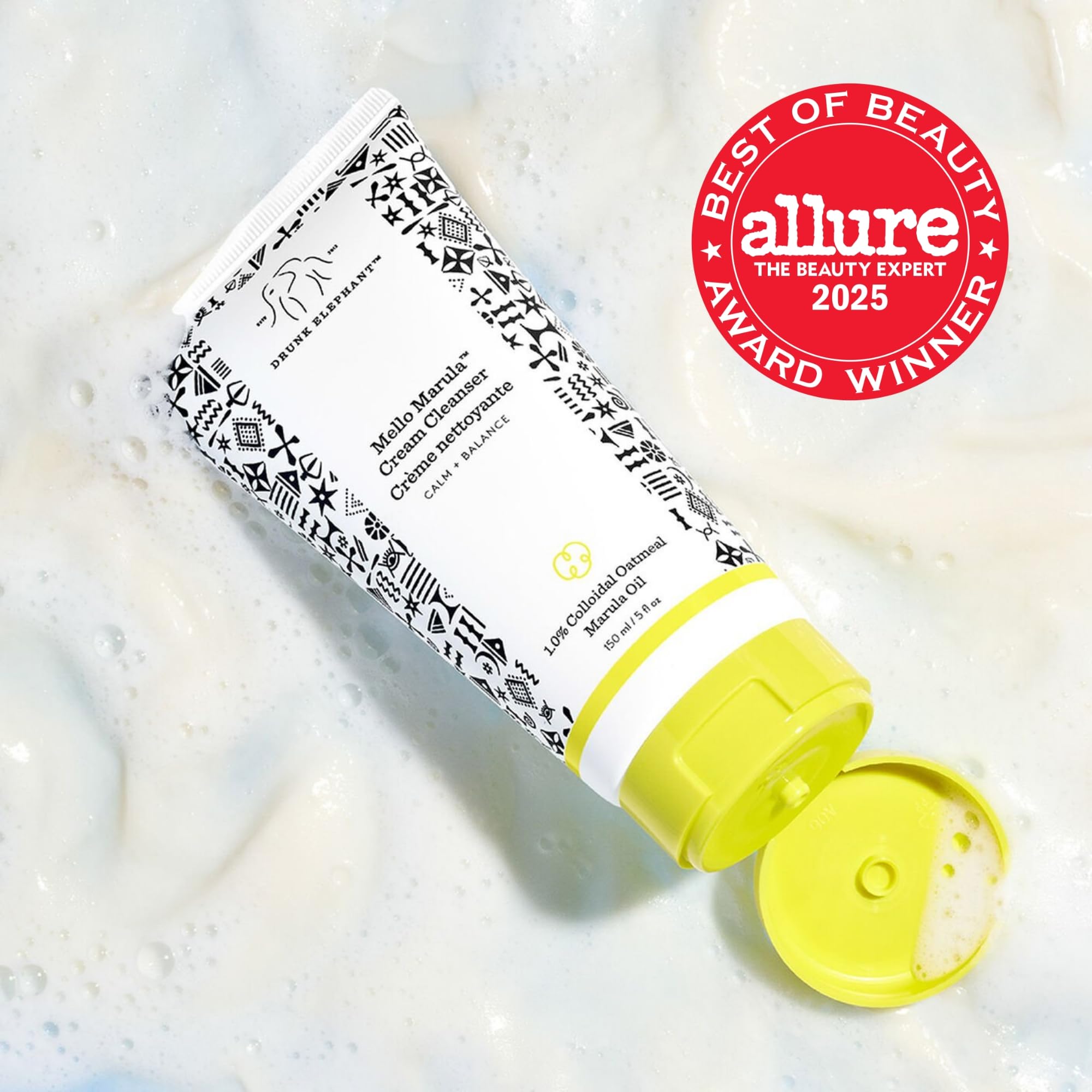 Drunk Elephant Mello Marula Cream Cleanser pump closeup showing soft lather for makeup removal.