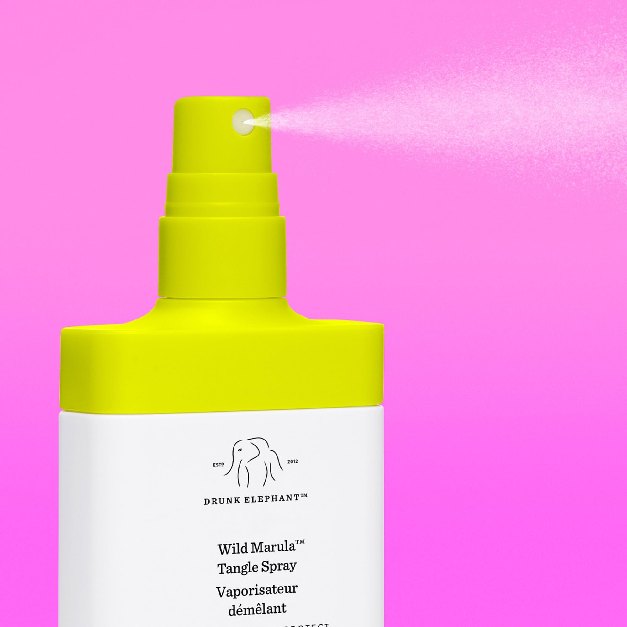 Drunk Elephant Wild Marula Tangle Spray demonstrates heat protection before styling sessions.