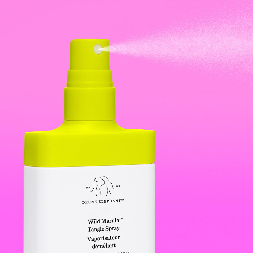Drunk Elephant Wild Marula Tangle Spray demonstrates heat protection before styling sessions.