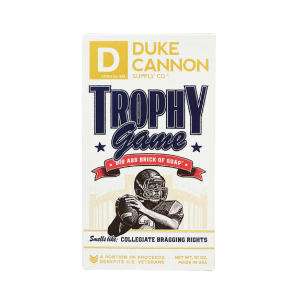 Duke Cannon Trophy Game 10oz bar shown beside hand for scale and durability.