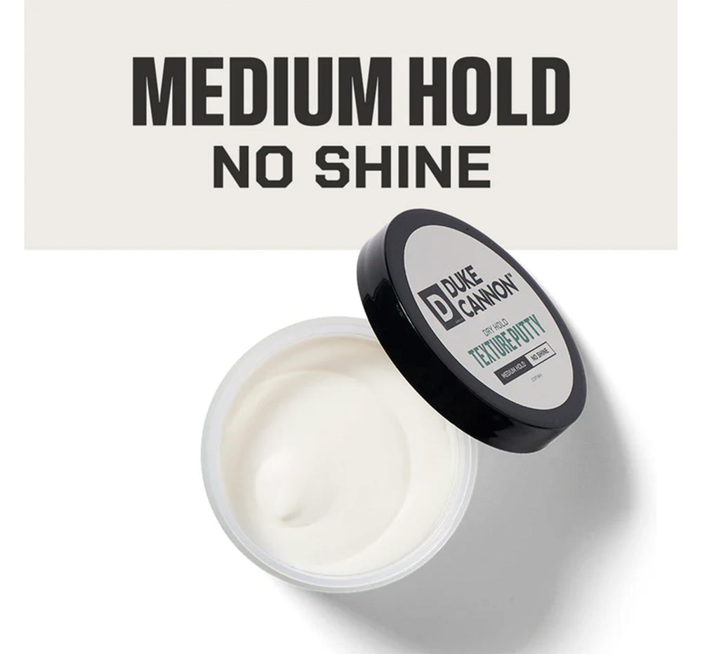 Duke Cannon Dry Hold Putty being warmed between hands for easy application.