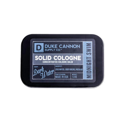 Duke Cannon Midnight Swim solid cologne tin closeup shows compact travel-ready scent