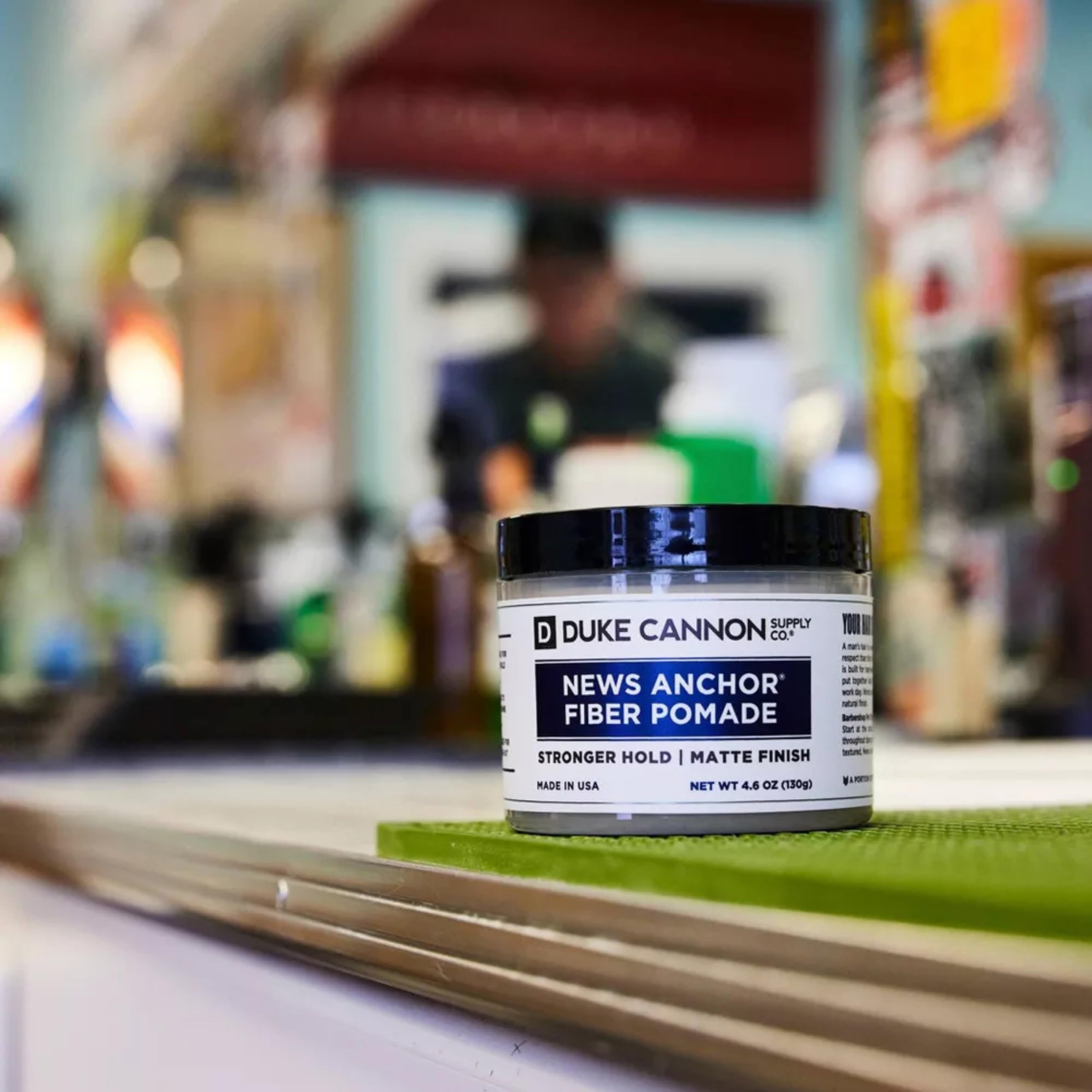 Duke Cannon News Anchor Fiber Pomade tube showing natural matte finish for versatile styling