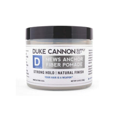 Duke Cannon News Anchor Pomade hands applying product for controlled, flexible hold