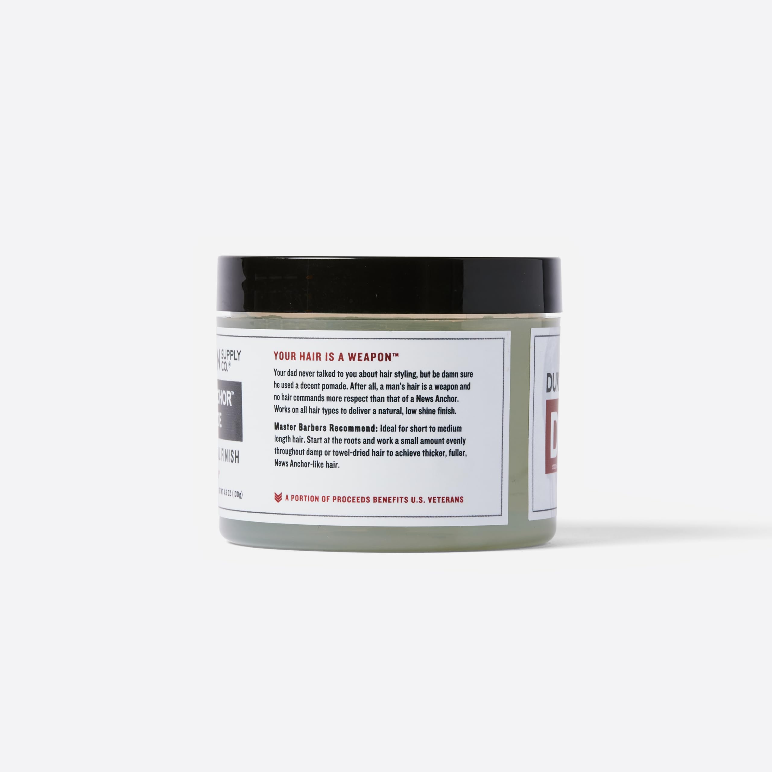 Duke Cannon News Anchor Pomade palm-application ready for quick styling.