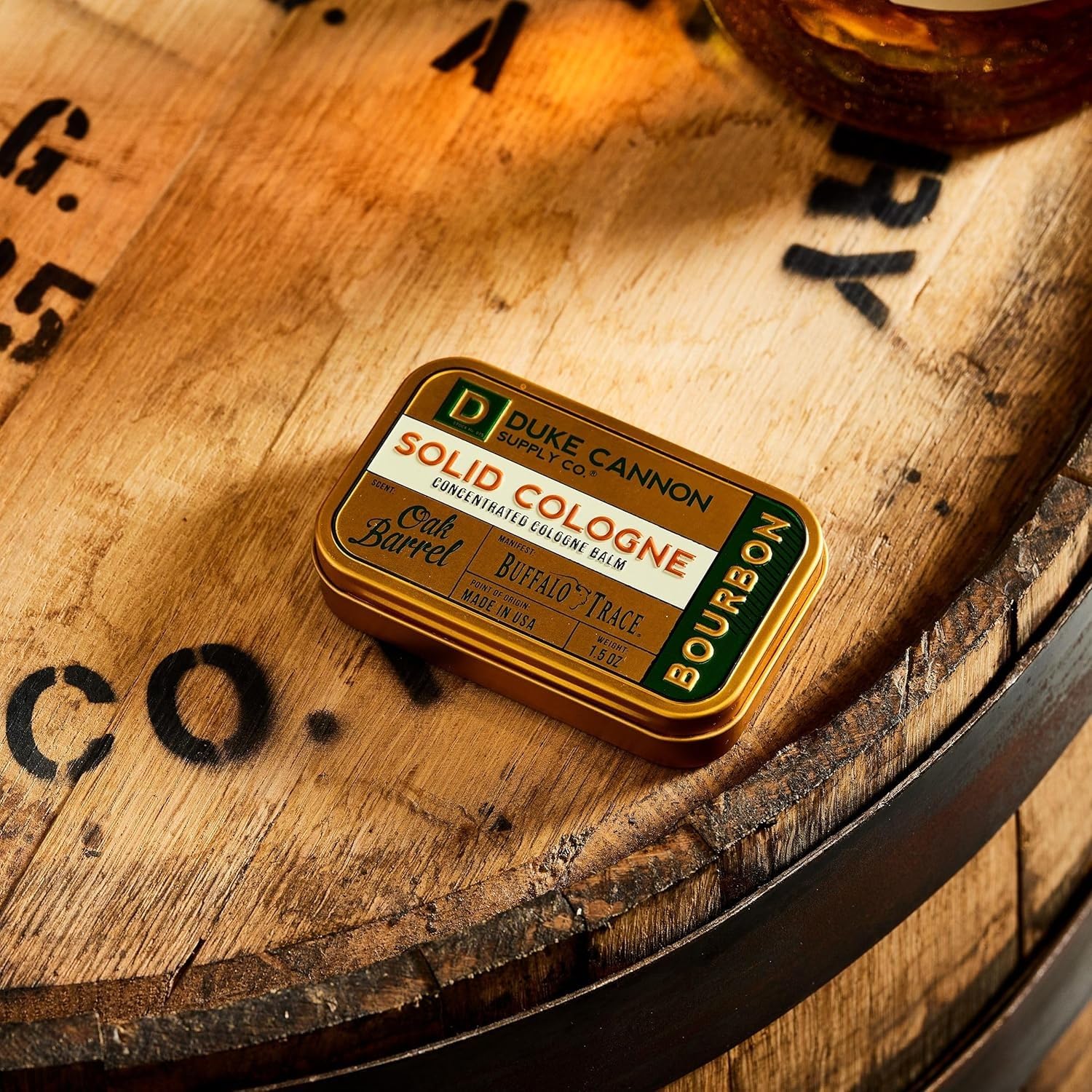 Duke Cannon Bourbon tin near travel case for convenient daily carry.