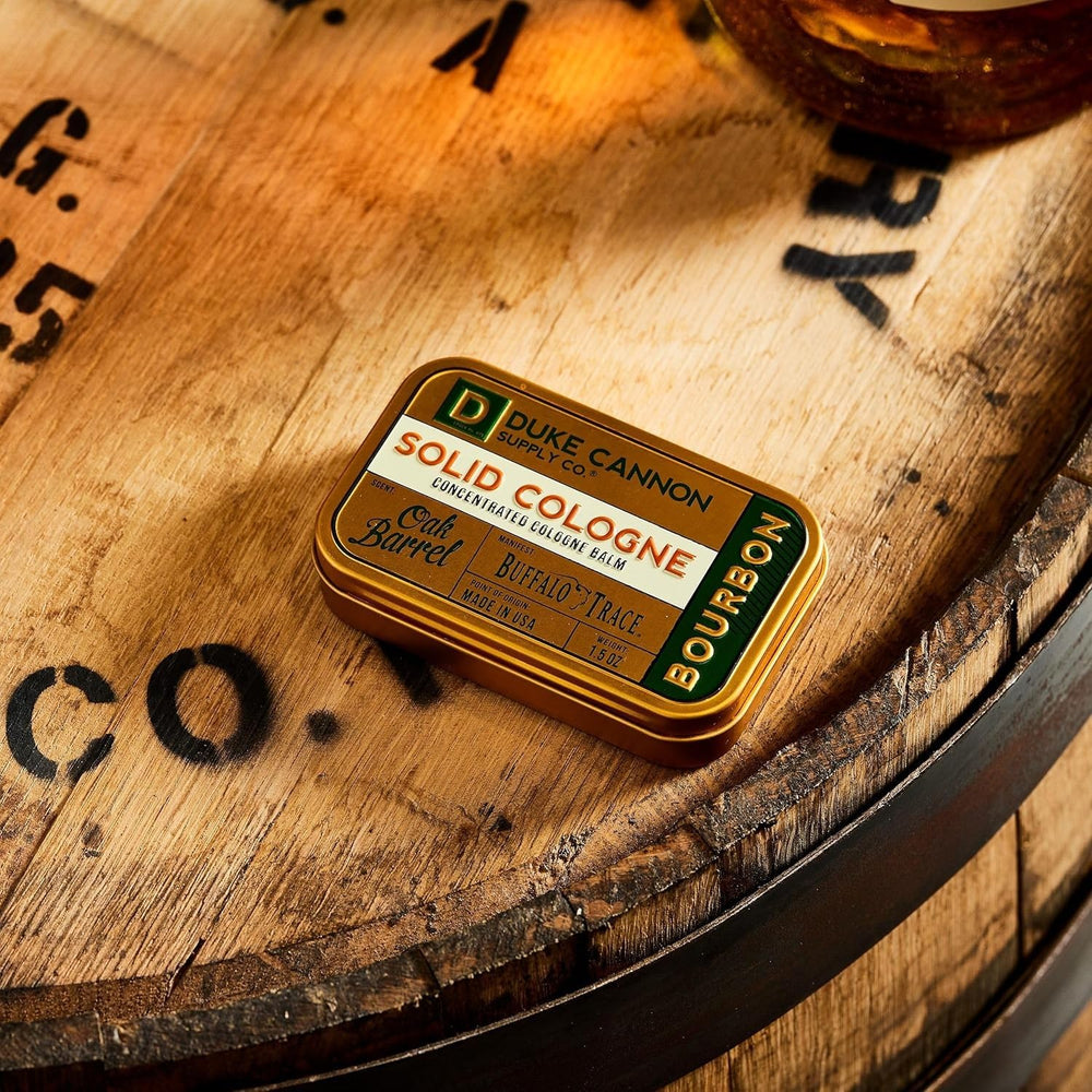 Duke Cannon Bourbon tin near travel case for convenient daily carry.