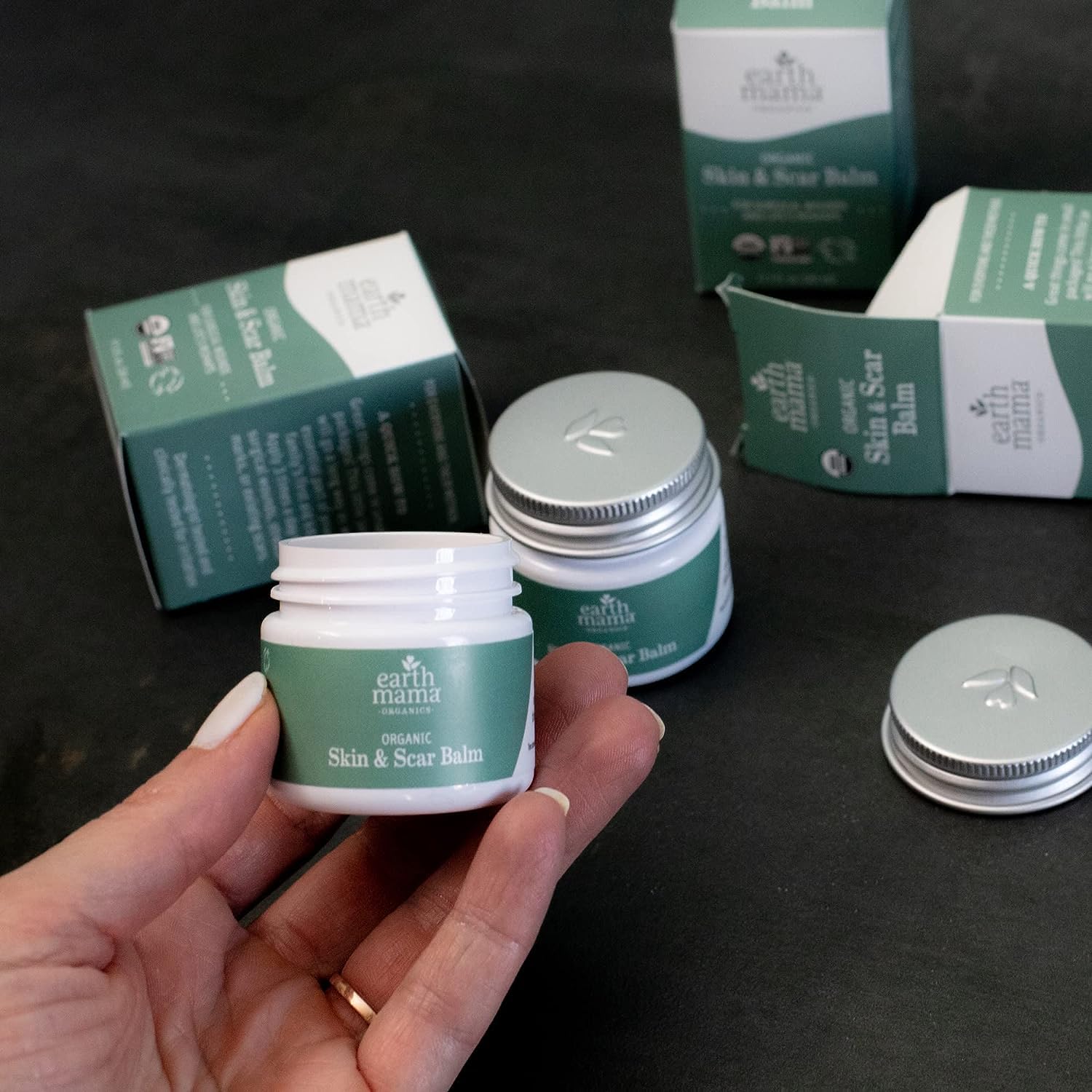 Earth Mama Organic Skin & Scar Balm ingredients list closeup with organic certification logos.