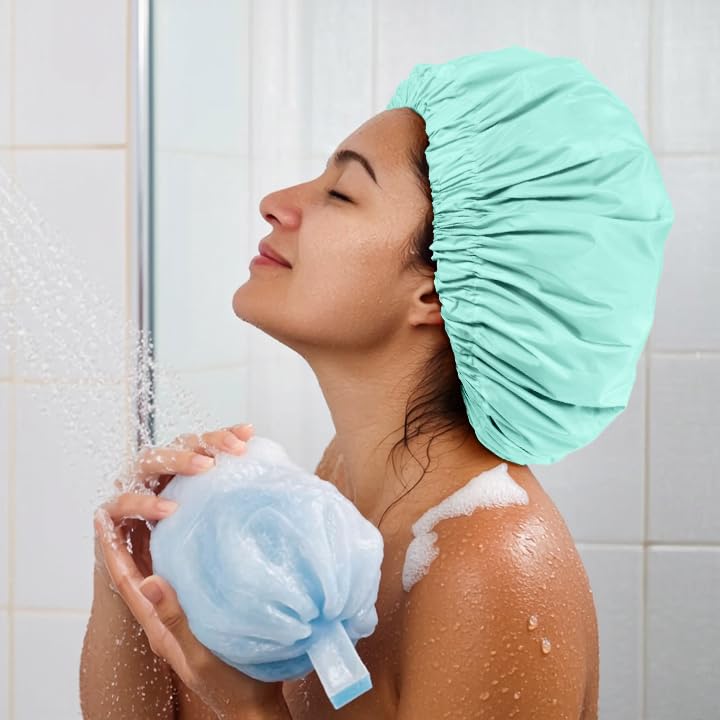 Edoneery mint-green cap in use during shower protects hair.
